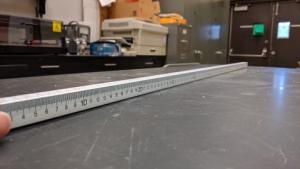 4-sided meter stick on a lab table