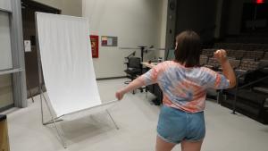 A student preparing to throw an egg at the sheet