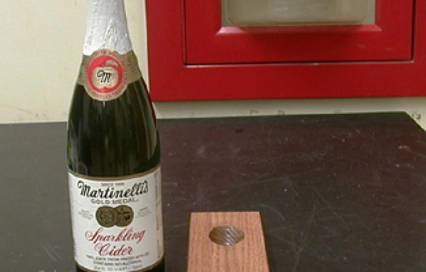 The wine butler is a single piece of wood with hole in it and beveled on the bot