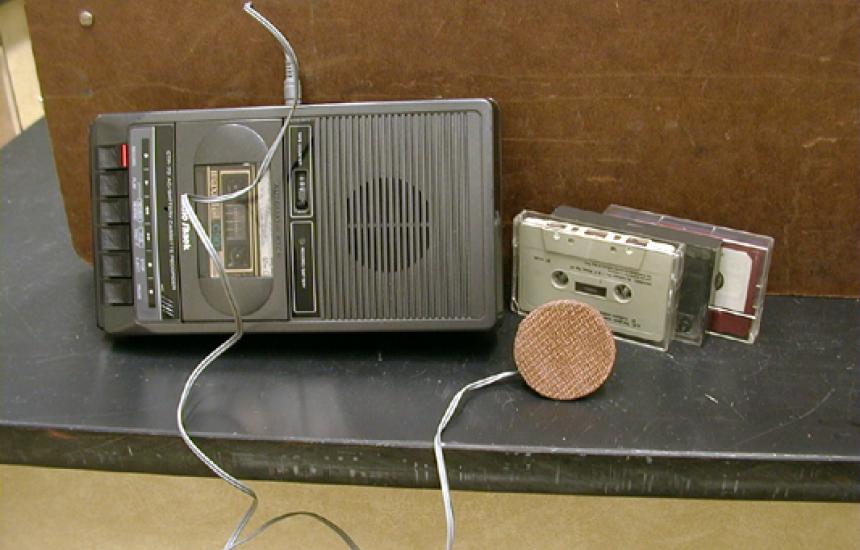 A tape is played through a small speaker.