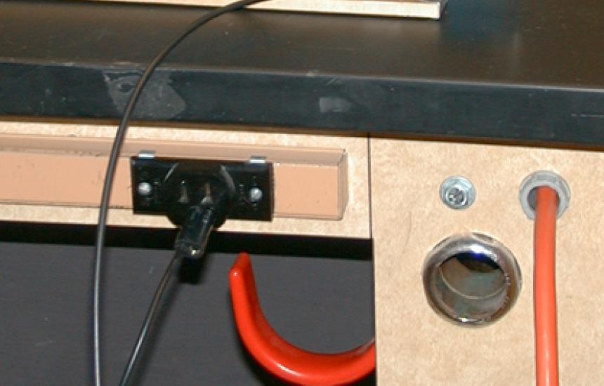 A ground wire is connected to the ground of the demo table outlet. The other end