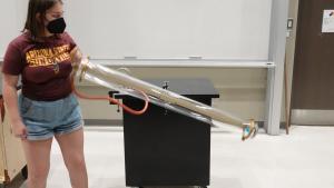 Tilting the tube to allow the penny and feather to fall together